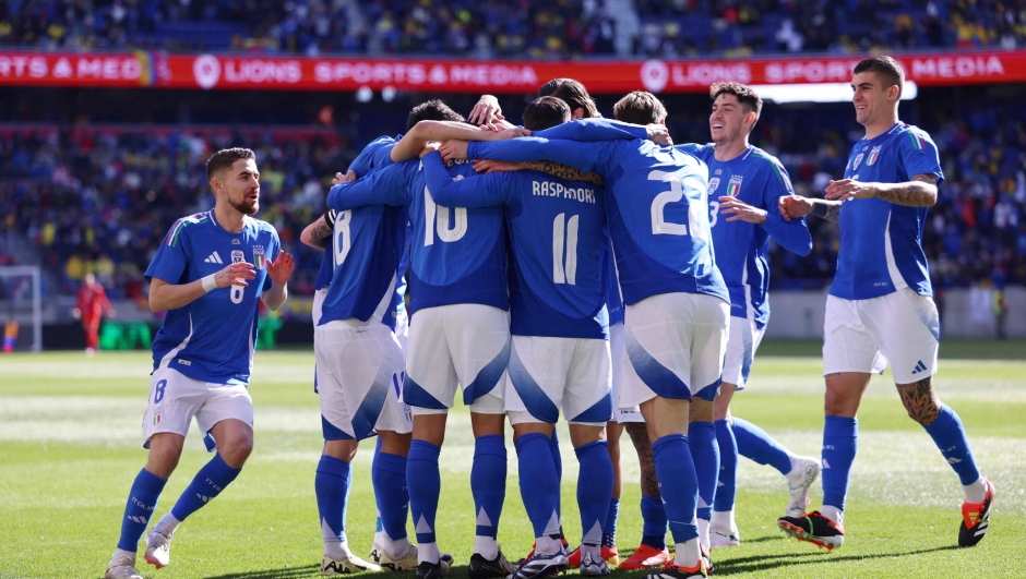 Italy's forward #10 Lorenzo Pellegrini is congratulated after scoring his team's first goal during the international friendly football match between Italy and Ecuador at Red Bull Arena in Harrison, New Jersey, on March 24, 2024. (Photo by Charly TRIBALLEAU / AFP)