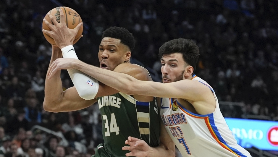 Milwaukee Bucks' Giannis Antetokounmpo is fouled by Oklahoma City Thunder's Chet Holmgren during the first half of an NBA basketball game Sunday, March 24, 2024, in Milwaukee. (AP Photo/Morry Gash)