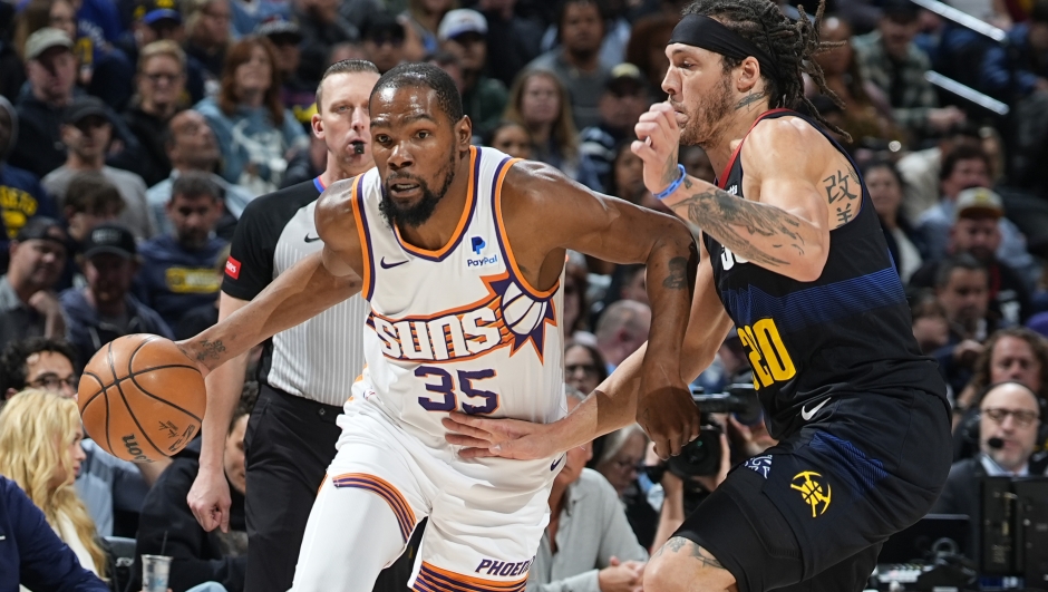 Phoenix Suns forward Kevin Durant drives past Denver Nuggets forward Aaron Gordon during the first half of an NBA basketball game Wednesday, March 27, 2024, in Denver. (AP Photo/David Zalubowski)