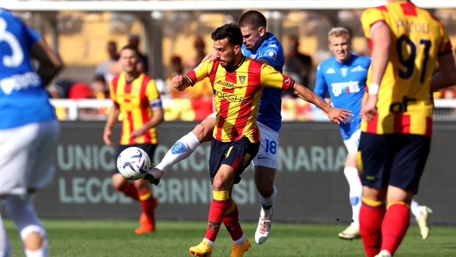 LECCE, ITALY - APRIL 13: Nicola Sansone of Lecce competes for the ball with Razvan Marin of Empoli during the Serie A TIM match between US Lecce and Empoli FC at Stadio Via del Mare on April 13, 2024 in Lecce, Italy. (Photo by Maurizio Lagana/Getty Images)
