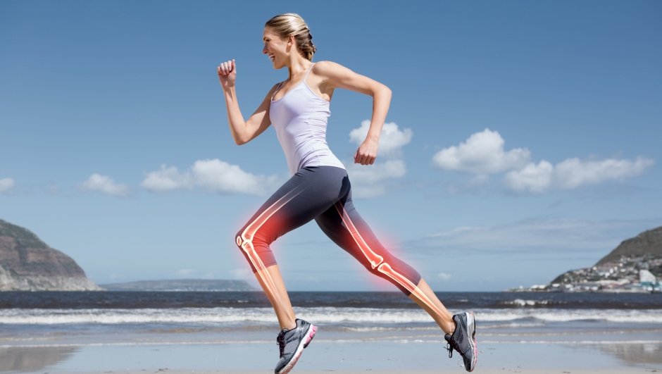 Digital composite of Highlighted leg bones of jogging woman on beach