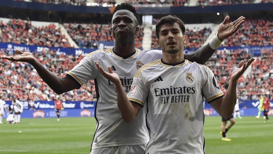Real Madrid's Brahim Diaz, right, celebrates with teammate Real Madrid's Vinicius Junior after scoring his side's third goal during the Spanish La Liga soccer match between Osasuna and Real Madrid at the El Sadar stadium in Pamplona, Spain, Saturday, March 16, 2023. (AP Photo/Alvaro Barrientos)