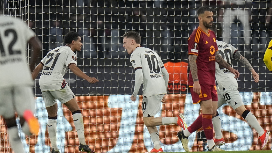 Leverkusen's Florian Wirtz, centre, celebrates after scoring his side's opening goal during the Europa League semifinal first leg soccer match between Roma and Bayer Leverkusen at Rome's Olympic Stadium, Italy, Thursday, May 2, 2024. (AP Photo/Alessandra Tarantino)