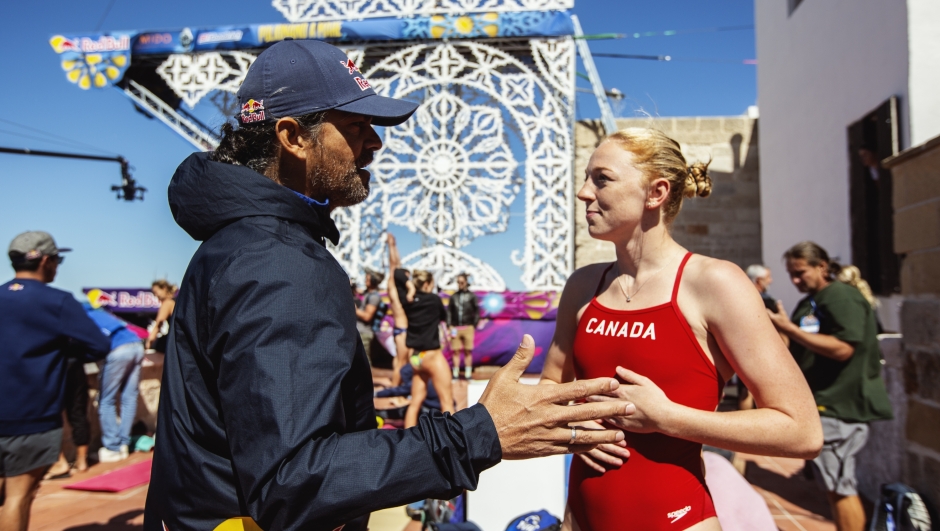 Sports director Orlando Duque talks to Molly Carlson in the Divers Area during the final competition day of the seventh stop of the Red Bull Cliff Diving World Series at Polignano a Mare, Italy on September 18, 2022.