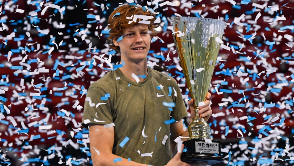 Italian tennis player Jannik Sinner celebrates with the trophy during the podium ceremony after winning the final against his Canadian opponent at the ATP 250 Sofia Open tennis tournament in Sofia, on November 14, 2020. (Photo by NIKOLAY DOYCHINOV / AFP)