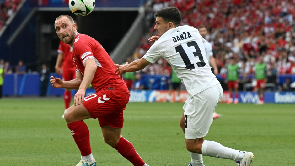 Denmark's midfielder #10 Christian Eriksen and Slovenia's defender #13 Erik Janza fights for the ball during the UEFA Euro 2024 Group C football match between Slovenia and Denmark at the Stuttgart Arena in Stuttgart on June 16, 2024. (Photo by THOMAS KIENZLE / AFP)