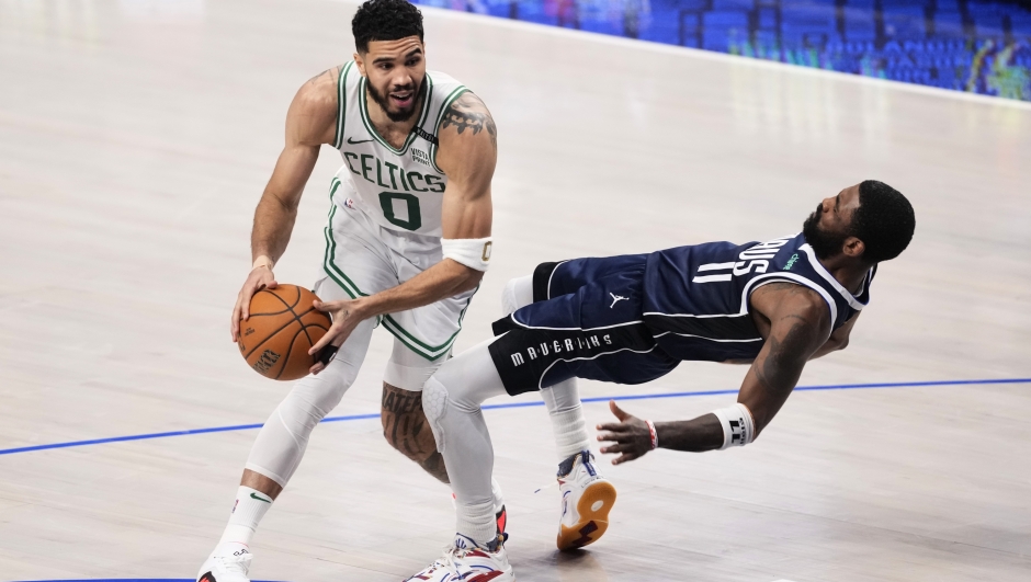 Boston Celtics forward Jayson Tatum (0) drives to the basket against Dallas Mavericks guard Kyrie Irving (11) during the first half in Game 4 of the NBA basketball finals, Friday, June 14, 2024, in Dallas. (AP Photo/Sam Hodde)