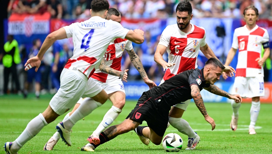 Albania's forward #07 Rey Manaj vies for the ball with Croatia's midfielder #11 Marcelo Brozovic and Croatia's defender #06 Josip Sutalo during the UEFA Euro 2024 Group B football match between Croatia and Albania at the Volksparkstadion in Hamburg on June 19, 2024. (Photo by JOHN MACDOUGALL / AFP)