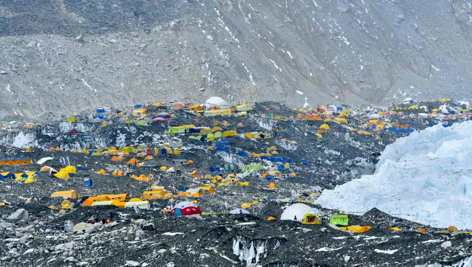 (FILES) In this photograph taken on April 30, 2021 expedition tents are seen at Everest Base Camp in the Mount Everest region of Solukhumbu district, some 140 km northeast of Nepal's capital Kathmandu. On Everest's sacred slopes, climate change is thinning snow and ice, increasingly exposing the bodies of hundreds of mountaineers who died chasing their dream to summit the world's highest mountain. "Because of the effects of global warming, (the bodies and trash) are becoming more visible as the snow cover thins," said Aditya Karki, a major in Nepal's army, who led the team of 12 military personnel and 18 climbers. (Photo by Prakash MATHEMA / AFP) / TO GO WITH 'Nepal-Mountains-Everest-Climbing' FOCUS by Paavan MATHEMA