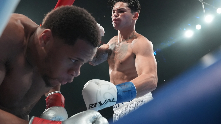 Ryan Garcia, right, punches Devin Haney during the first round of a super lightweight boxing match early Sunday, April 21, 2024, in New York. (AP Photo/Frank Franklin II)