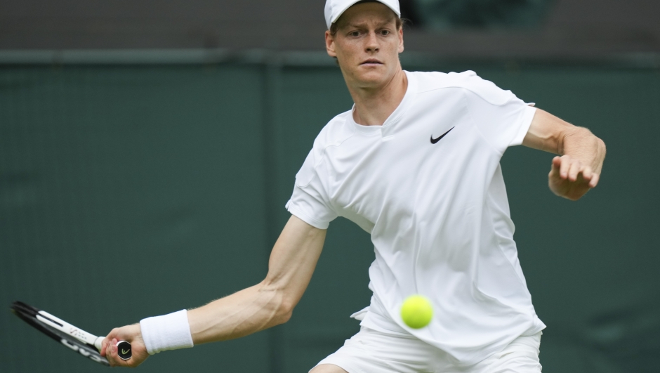 Jannik Sinner of Italy plays a forehand return to Yannick Hanfmann of Germany during their first round match of the Wimbledon tennis championships in London, Monday, July 1, 2024. (AP Photo/Mosa'ab Elshamy)