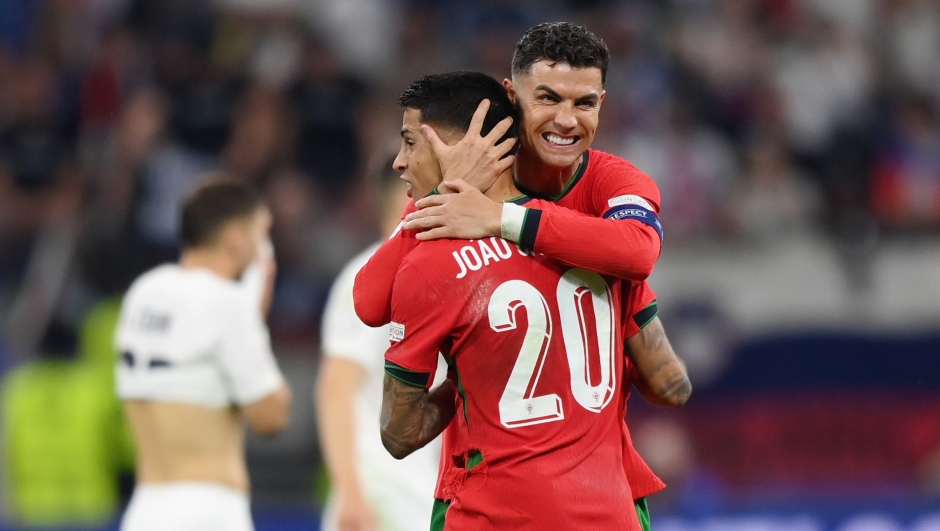 FRANKFURT AM MAIN, GERMANY - JULY 01: Cristiano Ronaldo and Joao Cancelo of Portugal celebrate following the team's victory in the penalty shoot out during the UEFA EURO 2024 round of 16 match between Portugal and Slovenia at Frankfurt Arena on July 01, 2024 in Frankfurt am Main, Germany. (Photo by Justin Setterfield/Getty Images)
