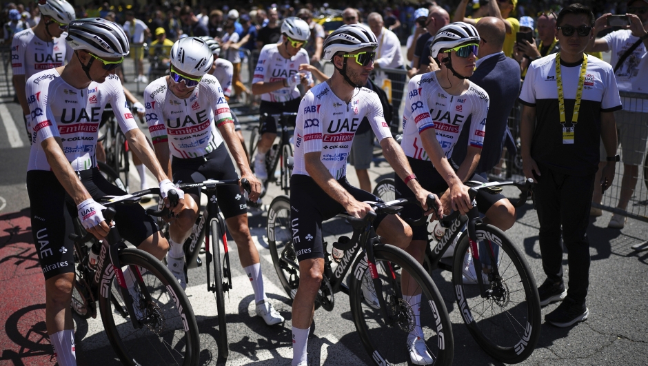 Team UAE riders wait for the start of the fourth stage of the Tour de France cycling race over 139.6 kilometers (86.7 miles) with start in Pinerolo, Italy and finish in Valloire, France, Tuesday, July 2, 2024. (AP Photo/Daniel Cole)