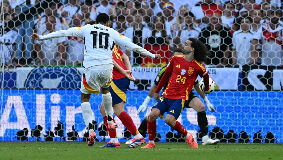 Spain's defender #24 Marc Cucurella blocks a shot by Germany's midfielder #10 Jamal Musiala during the UEFA Euro 2024 quarter-final football match between Spain and Germany at the Stuttgart Arena in Stuttgart on July 5, 2024. (Photo by THOMAS KIENZLE / AFP)