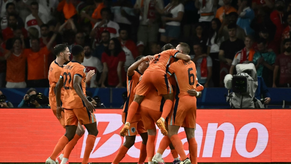 Netherlands' players celebrate their first goal during the UEFA Euro 2024 quarter-final football match between the Netherlands and Turkey at the Olympiastadion in Berlin on July 6, 2024. (Photo by Angelos Tzortzinis / AFP)