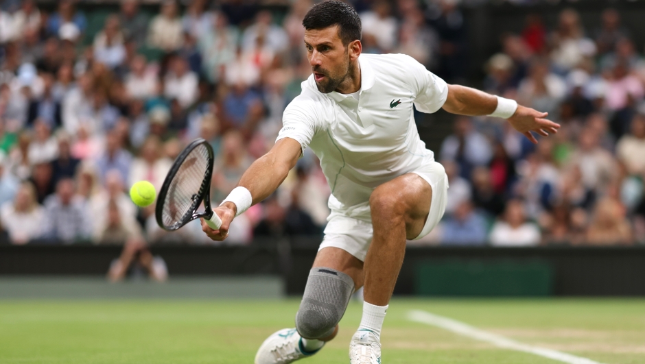 LONDON, ENGLAND - JULY 08: Novak Djokovic of Serbia plays a backhand against Holger Rune of Denmark in his Gentlemen's Singles fourth round match during day eight of The Championships Wimbledon 2024 at All England Lawn Tennis and Croquet Club on July 08, 2024 in London, England. (Photo by Julian Finney/Getty Images)