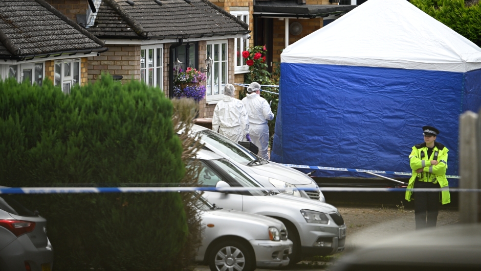BUSHEY, ENGLAND - JULY 10: Forensic officers stand beside the police tent as a police officer surveys the scene in Ashlyn Close on July 10, 2024 in Bushey, England. Hertfordshire Police have issued an urgent appeal for 26-year-old Kyle Clifford from the Enfield area to give himself up. Clifford is wanted in connection with the murder of three women in Bushey, believed to be the wife and two daughters of BBC racing commentator John Hunt. The women were found at their home in Bushey and all three died of their injuries yesterday evening. (Photo by Leon Neal/Getty Images)