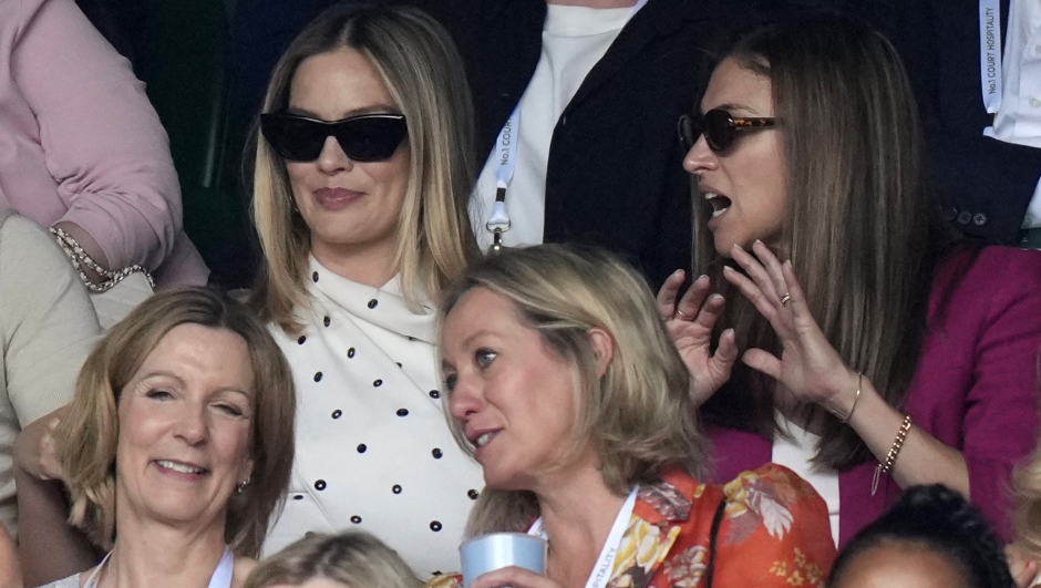 Margot Robbie, top left, in the stands as she attends the semifinal matches at the Wimbledon tennis championships in London, Friday, July 12, 2024. (AP Photo/Mosa'ab Elshamy)