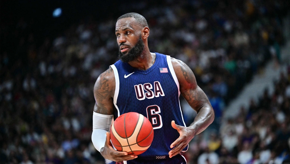 (FILES) USA's forward #06 LeBron James looks on during the Basketball Showcase friendly match between the United States and Australia at Etihad Arena in Abu Dhabi on July 15, 2024. LeBron James, the NBA's all-time leading points scorer, will be the male flagbearer for Team USA at the Paris Olympics, the USOPC announced on July 22, 2024. (Photo by Giuseppe CACACE / AFP)