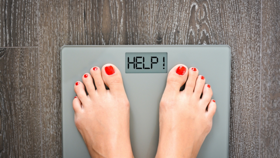 Lose weight concept with person on a scale measuring kilograms