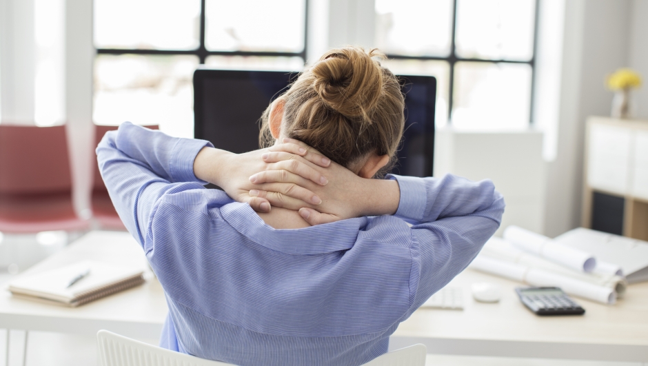 Tired businesswoman holding her nape