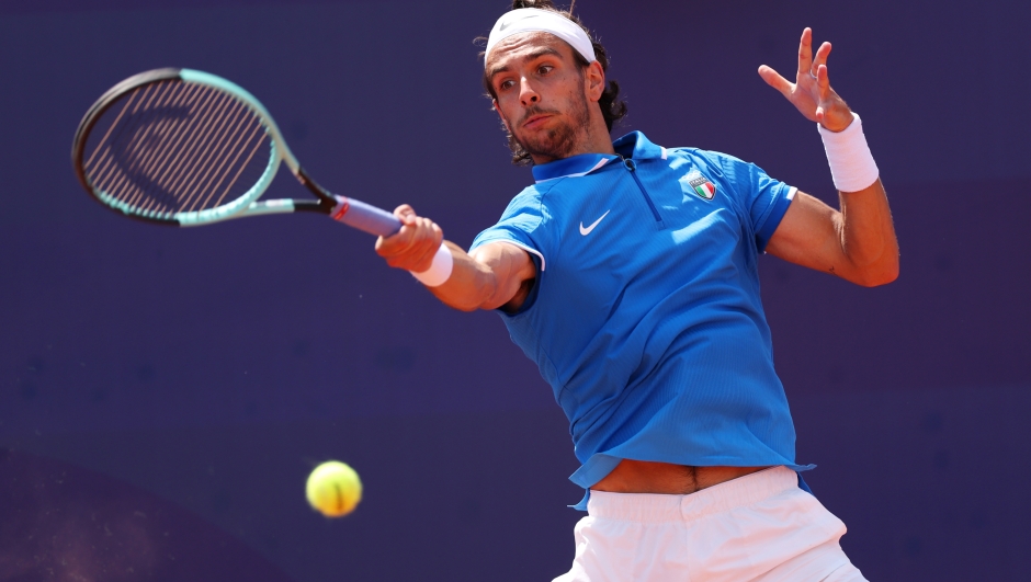 PARIS, FRANCE - JULY 31: Lorenzo Musetti of Team Italy plays a forehand against Taylor Fritz of Team United States during the Men's Singles Third Round match on day five of the Olympic Games Paris 2024 at Roland Garros on July 31, 2024 in Paris, France. (Photo by Matthew Stockman/Getty Images)