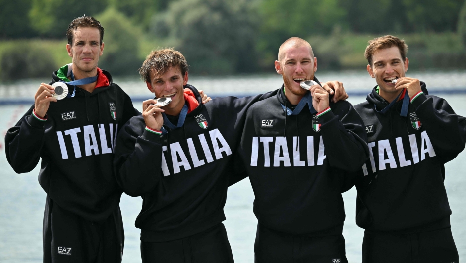 Italy's silver medallists Giacomo Gentili, Andrea Panizza, Luca Rambaldi and Luca Chiumento pose on the podium during the medal ceremony after the men's quadruple sculls final rowing competition at Vaires-sur-Marne Nautical Centre in Vaires-sur-Marne during the Paris 2024 Olympic Games on July 31, 2024. (Photo by Bertrand GUAY / AFP)