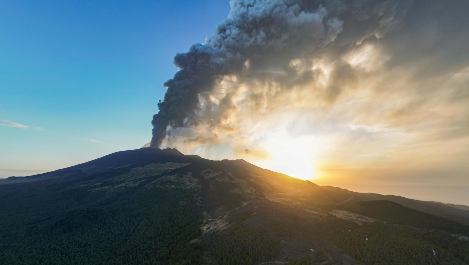 An aerial view shows a plum of ashes during an eruption of the Mount Etna volcano early on August 4, 2024 in Sicily. (Photo by Giuseppe Distefano / Etna Walk / AFP)