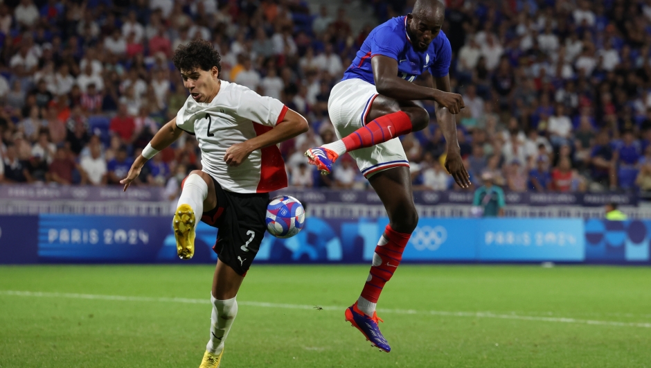 LYON, FRANCE - AUGUST 05: Jean-Philippe Mateta #14 of Team France and Fayed Omar #2 of Team Egypt battle for the ball during the Men's semifinal match between France and Egypt during the Olympic Games Paris 2024 at Stade de Lyon on August 05, 2024 in Lyon, France. (Photo by Claudio Villa/Getty Images)