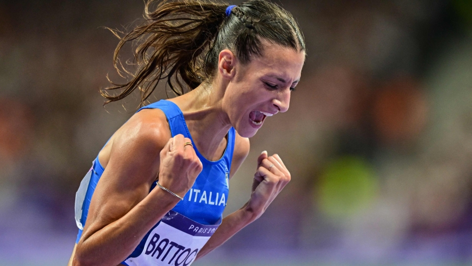 Second placed Italy's Nadia Battocletti celebrates after the women's 10000m final of the athletics event at the Paris 2024 Olympic Games at Stade de France in Saint-Denis, north of Paris, on August 9, 2024. (Photo by Martin  BERNETTI / AFP)