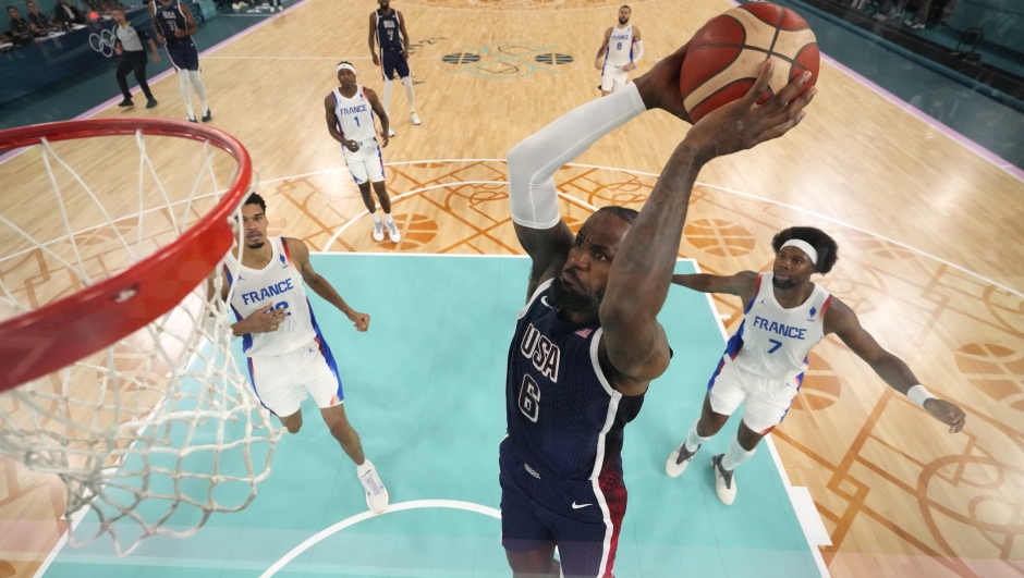 PARIS, FRANCE - AUGUST 10: (EDITORS NOTE: Image was captured using a remote camera positioned above the field of play) Lebron James #6 of Team United States dunks the ball during the Men's Gold Medal game between Team France and Team United States on day fifteen of the Olympic Games Paris 2024 at Bercy Arena on August 10, 2024 in Paris, France. (Photo by Pool/Getty Images)