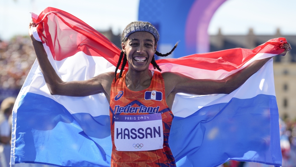 Sifan Hassan, of the Netherlands, celebrates after crossing the finish line to win the gold medal at the end of the women's marathon competition at the 2024 Summer Olympics, Sunday, Aug. 11, 2024, in Paris, France. (AP Photo/Vadim Ghirda)