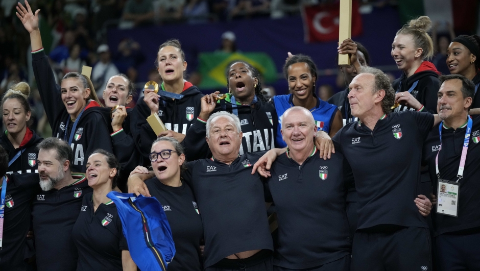 Italy's coach Julio Velasco, front row center, celebrate the gold medal with the team during the medal ceremony after the women's volleyball match against the United States at the 2024 Summer Olympics, Sunday, Aug. 11, 2024, in Paris, France. (AP Photo/Alessandra Tarantino)    Associated Press / LaPresse Only italy and Spain