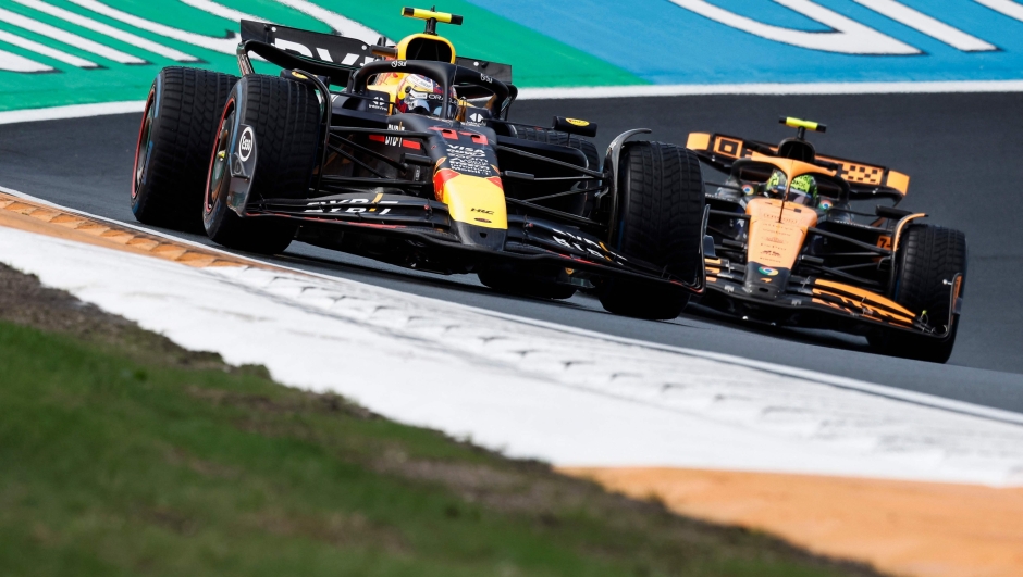 Red Bull Racing's Mexican driver Sergio Perez drives in front of McLaren's British driver Lando Norris during the first practice session at The Circuit Zandvoort, western Netherlands, on August 23, 2024, ahead of the Formula One Dutch Grand Prix. The Formula One Zandvoort Grand Prix race will take place on August 25, 2024. (Photo by SIMON WOHLFAHRT / AFP)