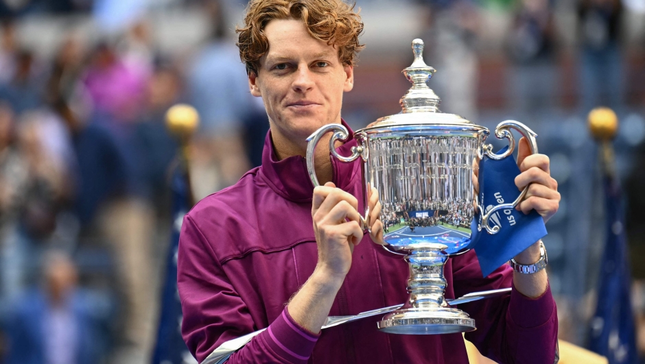 Italy's Jannik Sinner holds the trophy after winning his men's final match against USA's Taylor Fritz on day fourteen of the US Open tennis tournament at the USTA Billie Jean King National Tennis Center in New York City, on September 8, 2024. (Photo by ANGELA WEISS / AFP)