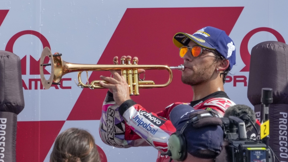 Italian rider Enea Bastianini of the Ducati Lenovo Team celebrates on the podium after winning the MotoGP race of the Emilia Romagna Motorcycle Grand Prix at the Misano circuit in Misano Adriatico, Italy, Sunday, Sept. 22, 2024. (AP Photo/Gregorio Borgia)