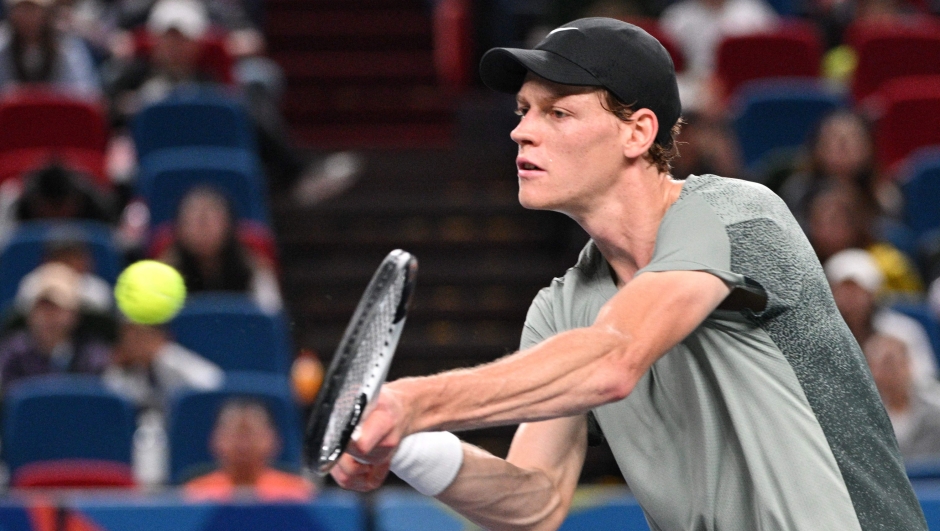 Italy's Jannik Sinner hits a return to Argentina's Tomas Martin Etcheverry during their men's singles match at the Shanghai Masters tennis tournament in Shanghai on October 6, 2024. (Photo by HECTOR RETAMAL / AFP)