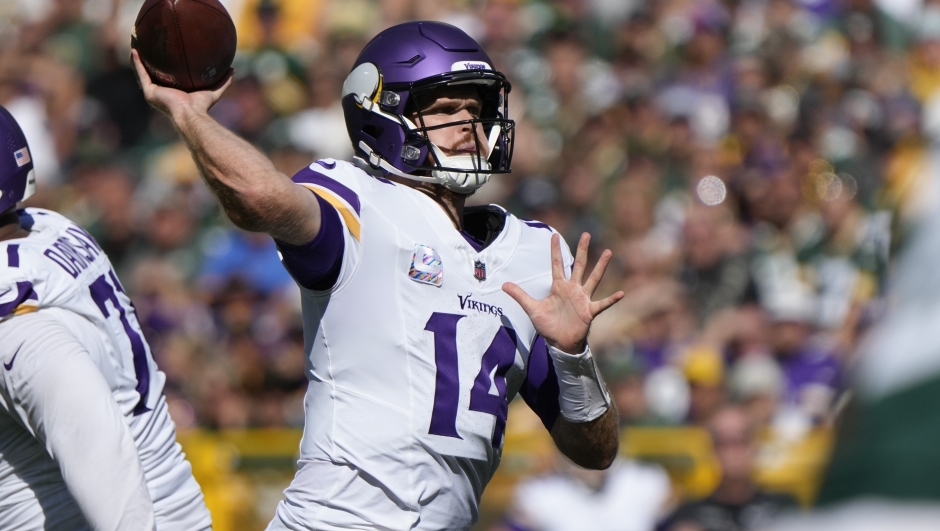 Minnesota Vikings quarterback Sam Darnold (14) looks to throw a pass during the second half of an NFL football game against the Green Bay Packers, Sunday, Sept. 29, 2024, in Green Bay, Wis. (AP Photo/Morry Gash)