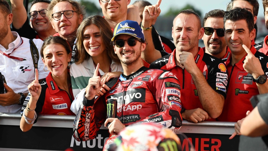 TOPSHOT - Ducati Lenovo Team rider Francesco Bagnaia of Italy (C) celebrates his victory at the parc ferme following the class race of the MotoGP Japanese Grand Prix at the Mobility Resort Motegi in Motegi, Tochigi prefecture on October 6, 2024. (Photo by Toshifumi KITAMURA / AFP)