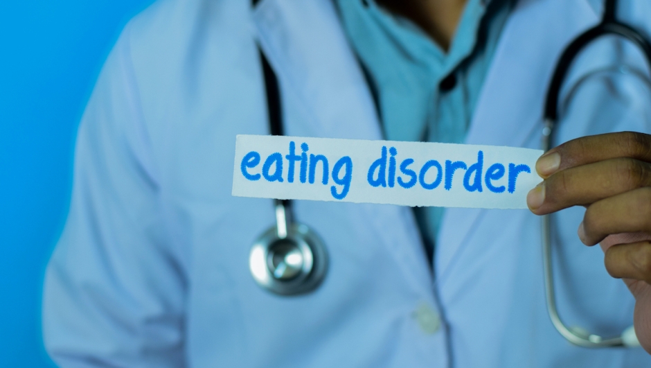 Doctor holding a card with text eating disorder. Medical and healthcare concept.