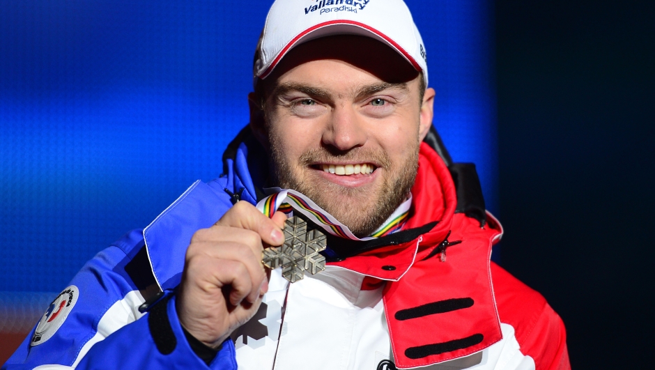 (FILES) This file photo taken on February 9, 2013 shows France's David Poisson holding his bronze medal during the medal ceremony after the men's downhill event of the 2013 Ski World Championships in Schladming, Austria. Skier David Poisson, 35, a World Championship bronze medalist in 2013, died on November 13, 2017 after a crash during a downhill training at the Canadian Nakiska Station, announced the French Ski Federation (FFS). / AFP PHOTO / Olivier MORIN