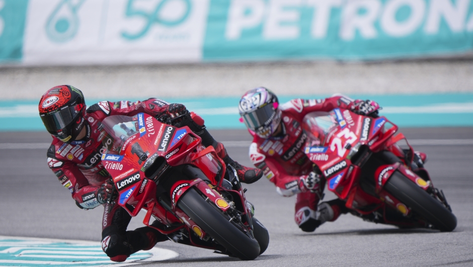 Italian rider Francesco Bagnaia of Ducati Lenovo Team, left, and Italian rider Enea Bastianini of Ducati Lenovo Team take a turn with their motorcycle during a free practice at Sepang International Circuit ahead of MotoGP race in Sepang, outskirts of Kuala Lumpur, Friday, Nov. 1, 2024. (AP Photo/Vincent Thian)