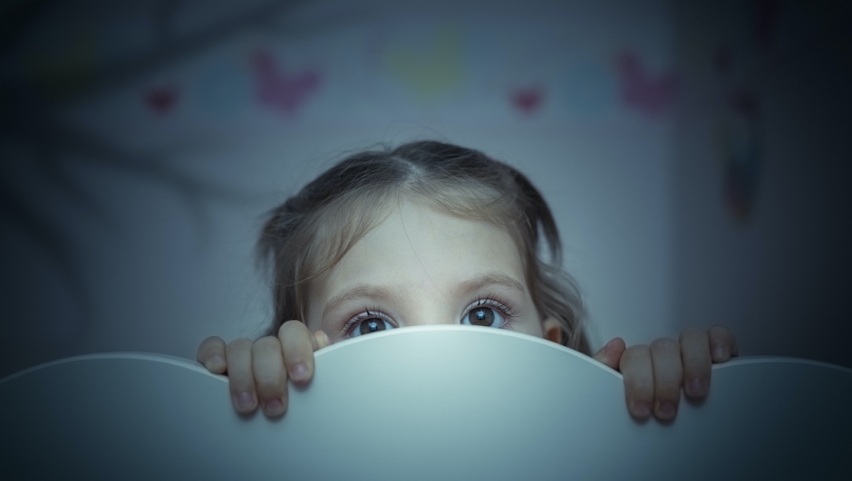 little girl is afraid of shadow of tree