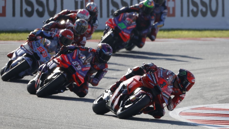 Italian rider Francesco Bagnaia of the Ducati Lenovo Team steers his motorcycle followed by Spain's rider Jorge Martin of the Prima Pramac Racing and Spain's rider Marc Marquez of the Gresini Racing MotoGP during the MotoGP race of the Grand Prix of Barcelona at the Catalunya racetrack in Montmelo, just outside of Barcelona, Spain, Sunday, Nov. 17, 2024. (AP Photo/Joan Monfort)