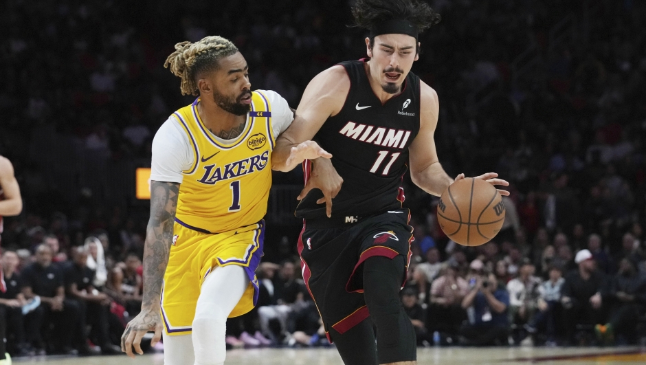 Los Angeles Lakers guard D'Angelo Russell (1) defends Miami Heat guard Jaime Jaquez Jr. (11) during the second half of an NBA basketball game, Wednesday, Dec. 4, 2024, in Miami. (AP Photo/Marta Lavandier)