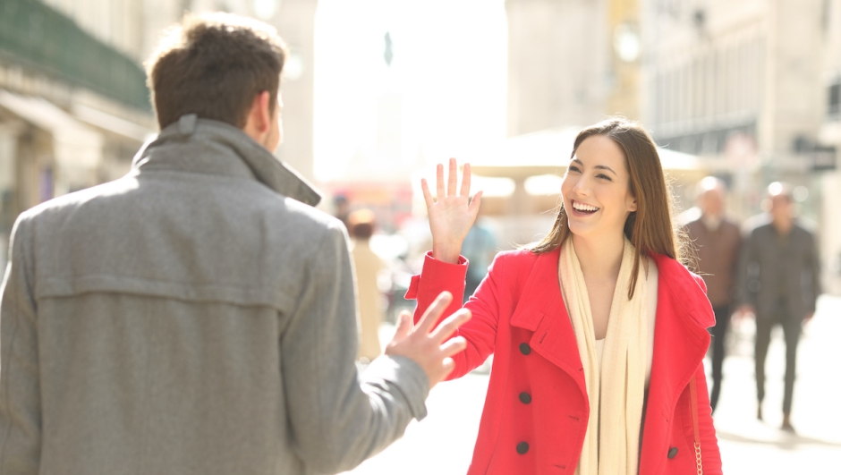 Happy friends meeting and greeting in the street