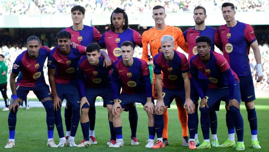 Team Barcelona pose for a photo before the Spanish league football match between Real Betis and FC Barcelona at the Benito Villamarin stadium in Seville on December 7, 2024. (Photo by CRISTINA QUICLER / AFP)