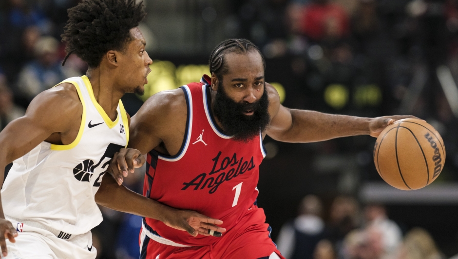 Los Angeles Clippers guard James Harden (1) drives the ball against Utah Jazz guard Collin Sexton (2) during the first half of an NBA basketball game Monday, Dec. 16, 2024, in Inglewood, Calif. (AP Photo/William Liang)