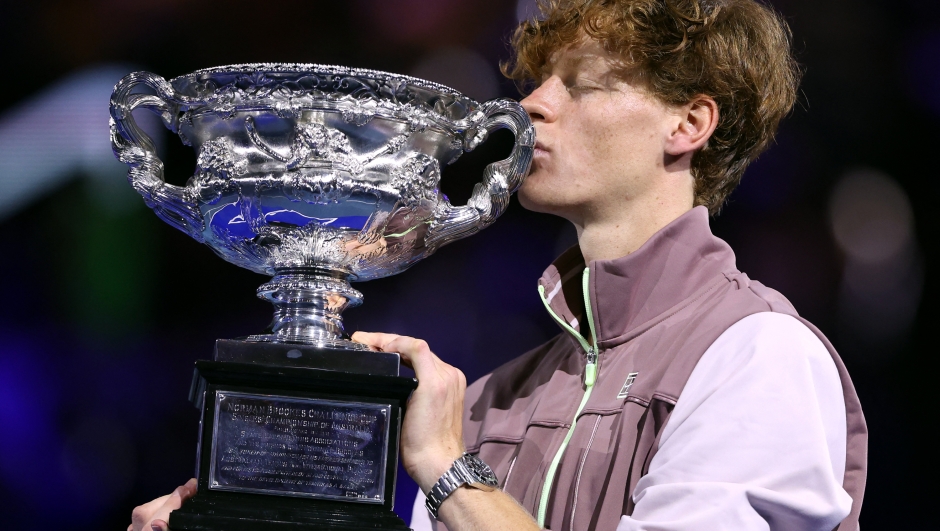 Italy's Jannik Sinner celebrates with the Norman Brookes Challenge Cup trophy after defeating Russia's Daniil Medvedev in the men's singles final match on day 15 of the Australian Open tennis tournament in Melbourne on January 28, 2024. (Photo by Martin KEEP / AFP) / -- IMAGE RESTRICTED TO EDITORIAL USE - STRICTLY NO COMMERCIAL USE --