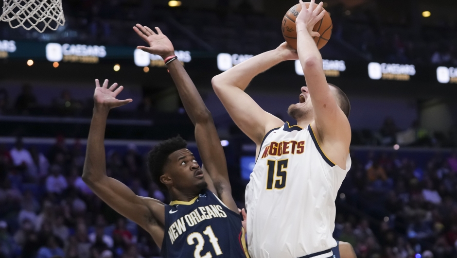 Denver Nuggets center Nikola Jokic (15) goes to the basket against New Orleans Pelicans center Yves Missi (21) in the second half of an NBA basketball game in New Orleans, Sunday, Dec. 22, 2024. The Nuggets won in overtime 132-129. (AP Photo/Gerald Herbert)